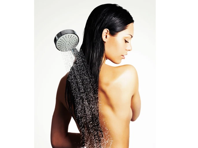 Photo of a woman in shower washing long hair